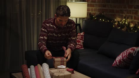 Young-adult-man-packing-Christmas-gifts